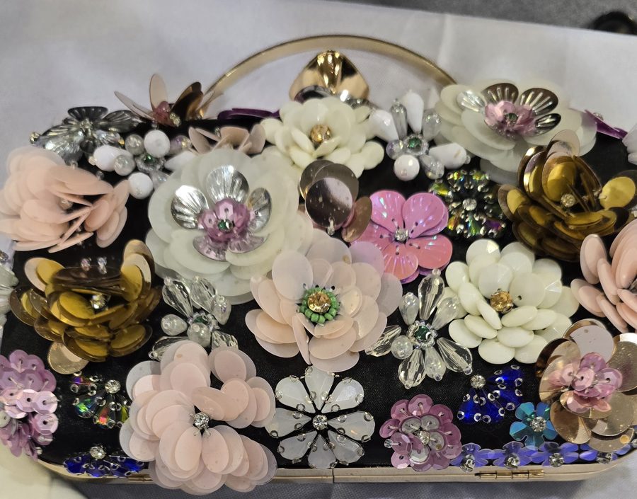 Black clutch covered in sequin and bead flowers